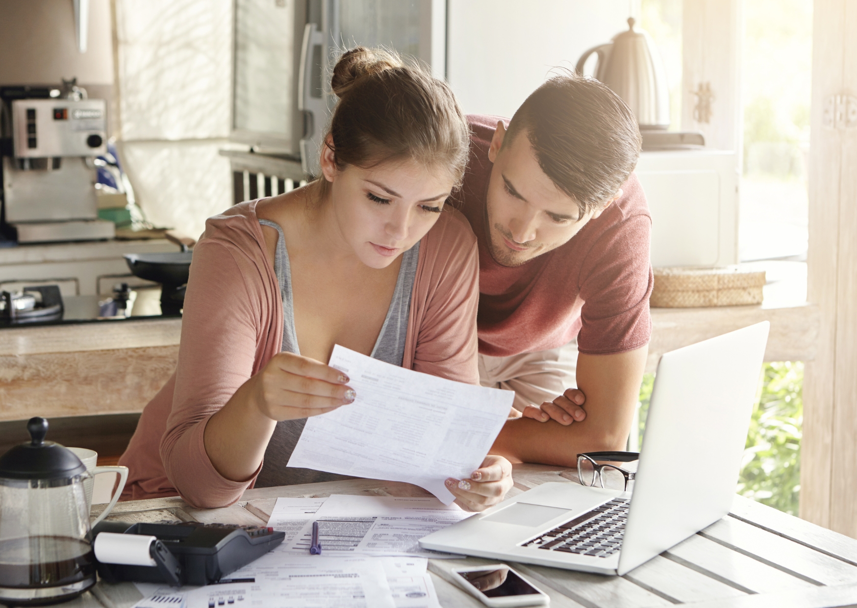 Couple working on their budget at a laptop