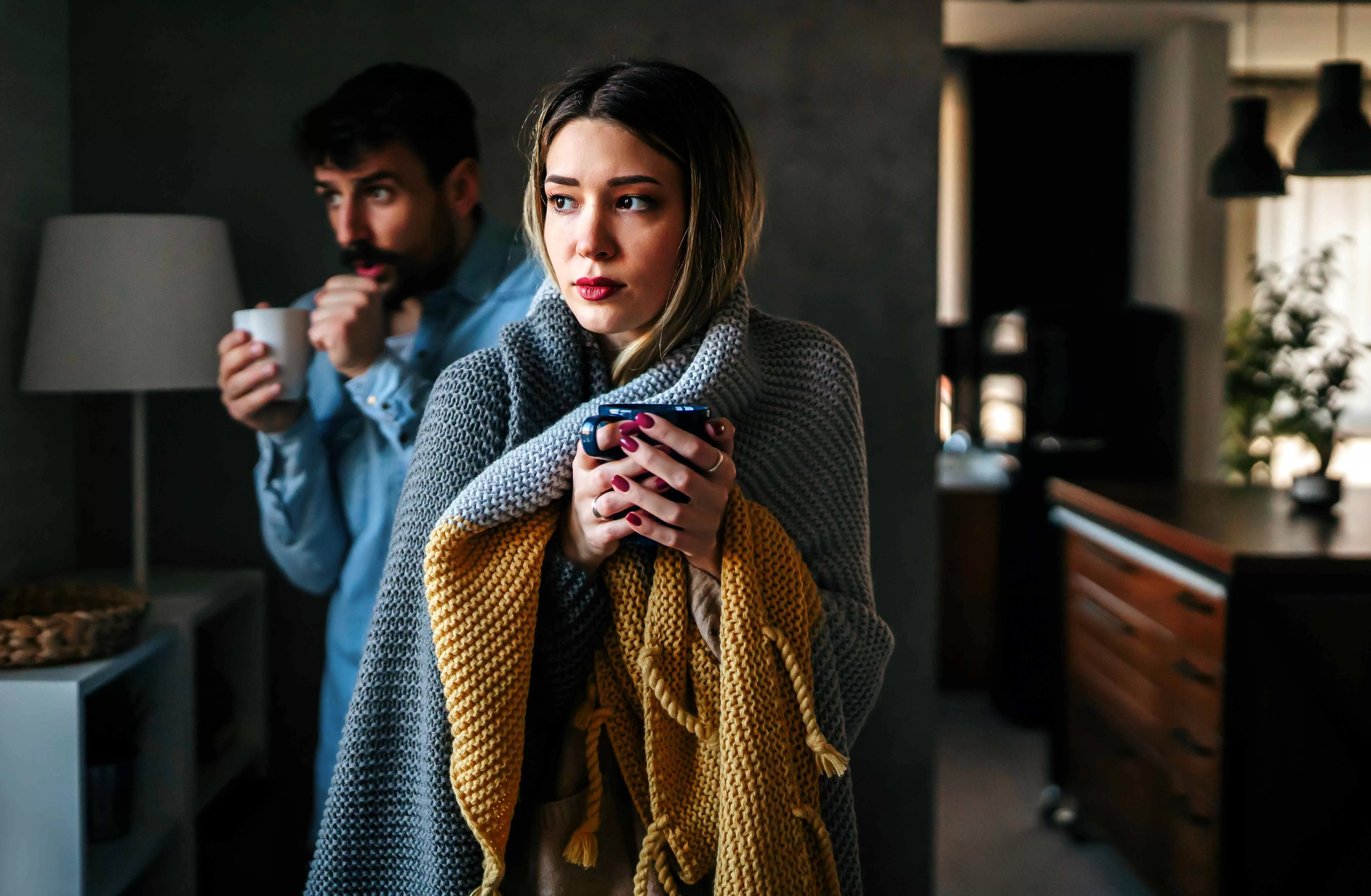 Man and woman trying to stay warm